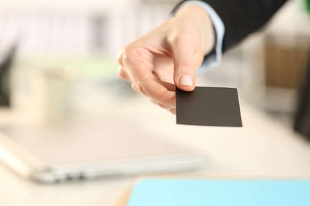 Close up of business woman hand giving business card at the officeの写真素材