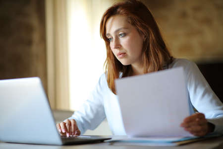 Concentrated entrepreneur working online at home or hotel roomの写真素材