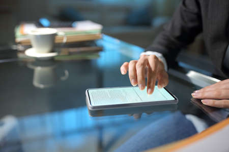 Close up of an executive hand filling online form on smart phone in the night at officeの写真素材