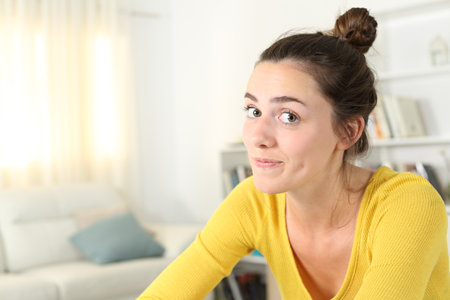 Portrait of a funny woman looking at camera at homeの写真素材