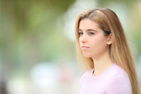 Serious teen looking away in the streetの写真素材