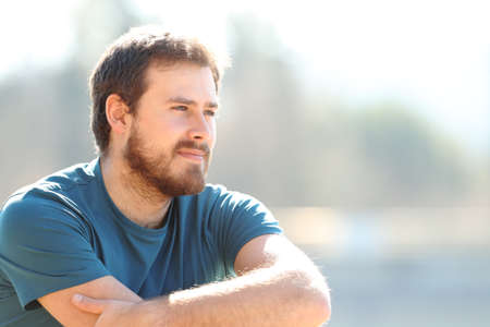 Pensive man contemplating views sitting outdoorsの写真素材