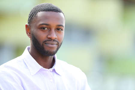 Confident man with black skin posing looking at you in the streetの写真素材