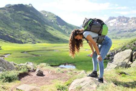 Profile of an exhausted hiker resting after climbing a mountainの写真素材