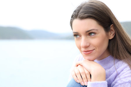 Confident woman relaxing and contemplating natureの写真素材