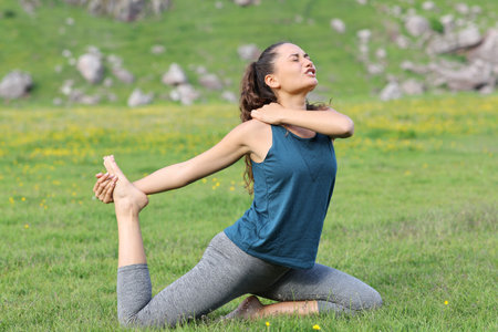 Yogi suffering accident in shoulder complaining while is doing yoga exerciseの写真素材