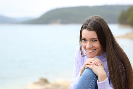 Happy teen smiling in a lake looking at camera in a lakeの写真素材