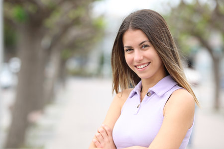 Happy teen posing standing in the streetの写真素材
