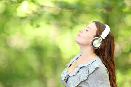 Profile of a woman meditating listening audio guideの写真素材