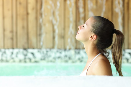 Side view portrait of a woman breathing bathing in spaの写真素材