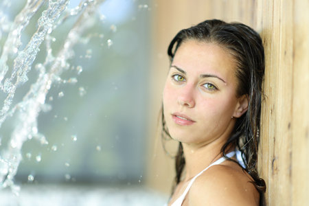 Beautiful woman bathing in spa looks at cameraの写真素材