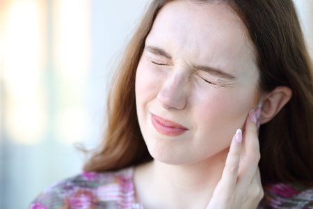 Woman suffering otitis and complaining in the streetの写真素材