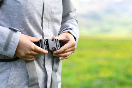 Vlose up of a hiker hands fixing backpack in the mountainの写真素材