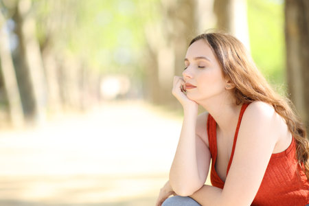 Woman relaxing and resting sitting in a parkの写真素材