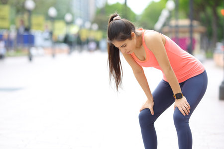 Exhausted runner resting in the street