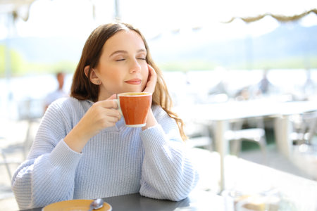 Restaurant customer relaxing drinking coffee in a terraceの写真素材
