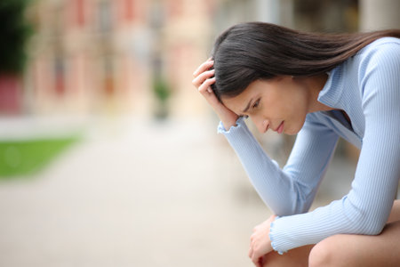 Profile of a sad woman complaining alone in a streetの写真素材