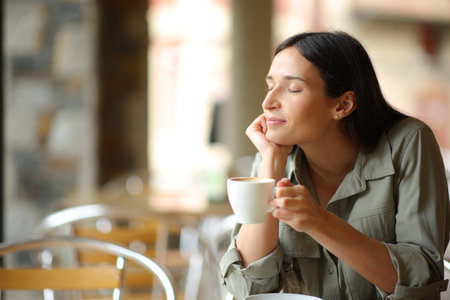 Woman relaxing drinking coffee in a restaurant terraceの写真素材