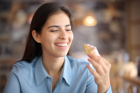 Happy woman looking at snack in a bar interiorの写真素材
