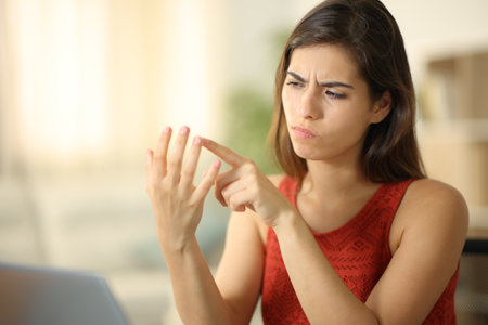 Worried and suspicious woman counting with fingers at homeの写真素材