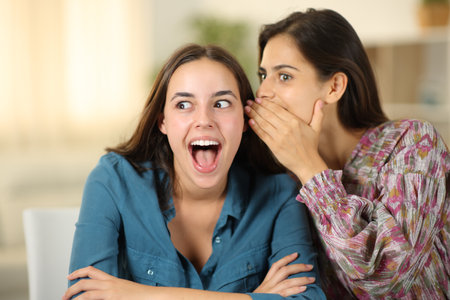 Woman telling amazing secret to a friend at homeの写真素材