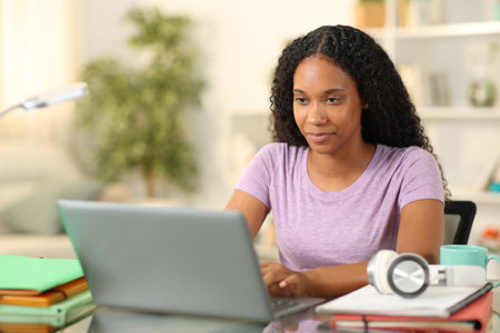 Black student elearning online with a laptop at homeの写真素材