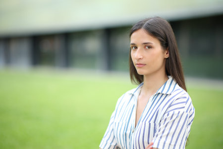 Portrait of a serious woman posing looking at camera in a business centerの写真素材