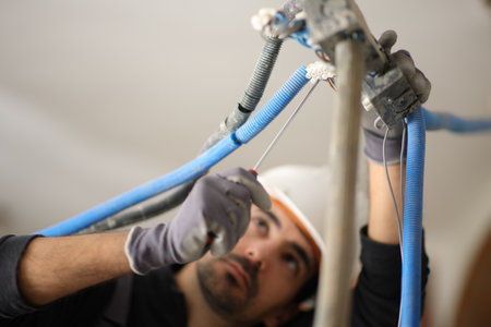 Electrician repairing electrical installation in a house under renovationの写真素材