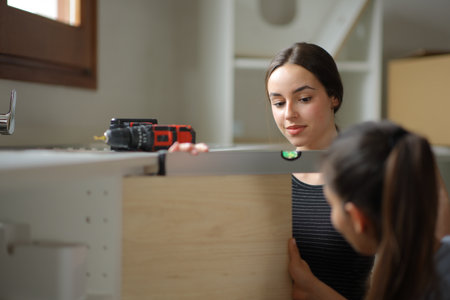 Roommates renovating house leveling furniture door in the kitchen