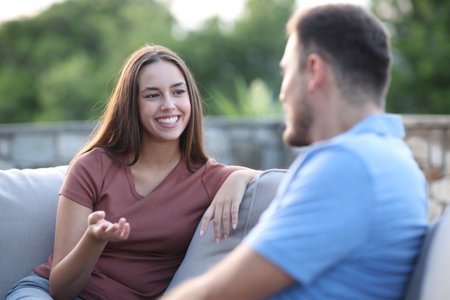 Man and woman talking on a terrace at homeの写真素材