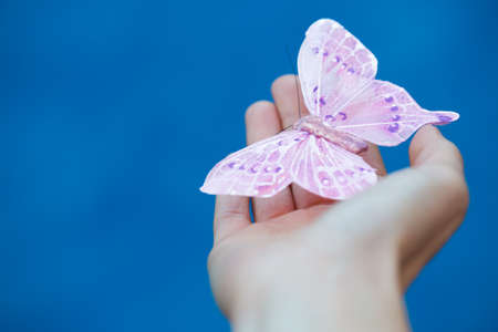 artificial butterfly on the hand, selective focusの写真素材