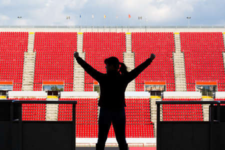 female football fan from behind in a empty stadium, selective focusの写真素材