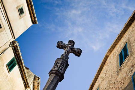 Old medieval Jesus on cross statue in the historic village in Valldemosa on the island  Majorca, creative editing to give the ancient aspectの写真素材