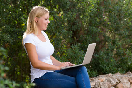 blond young women with laptop outdoor,selective focusの写真素材