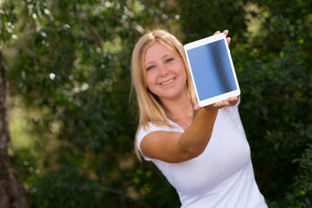 beautiful young women showing digital tablet outdoor,selective focusの写真素材