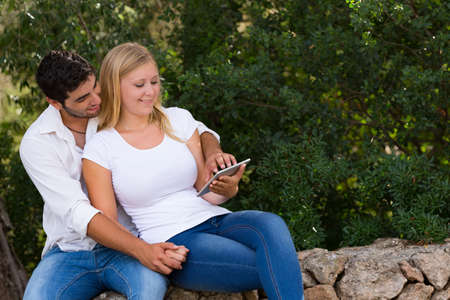 beautiful young couple  outdoor with digital tablet,selective focusの写真素材