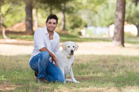 handsome latin man with old senior labrador dog,selective focusの写真素材