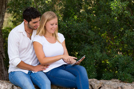 couple using internet outdoor with digital tablet,selective focusの写真素材