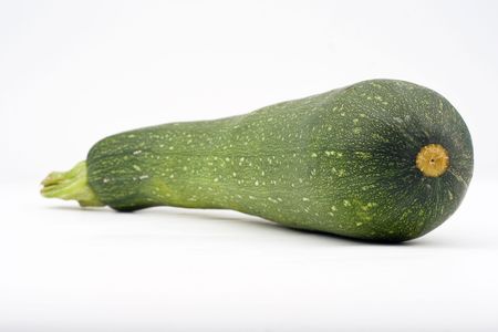 fresh zucchini isolated over whiteの写真素材