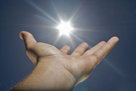 human hand, sun and blue skyの写真素材