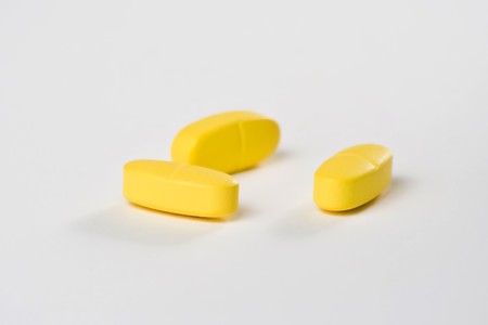 healthcare, various colours pharmacy pills and capsules isolated over whiteの写真素材