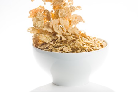 bowl of cereal with raisins, milk and orange juice