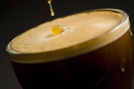 Espresso coffee cup with cream isolated on black