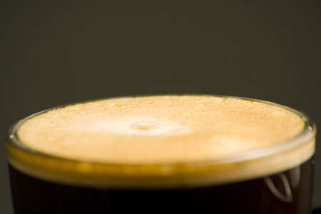 Espresso coffee cup with cream isolated on blackの写真素材