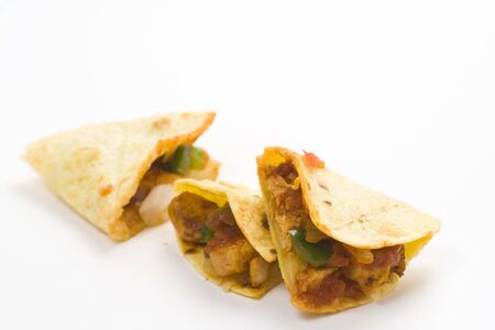 delicious chicken quesadilla and fresh vegetables isolatedの写真素材