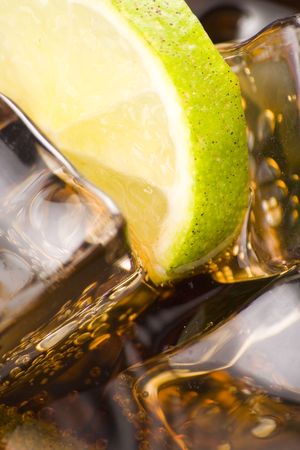 refreshing glass of cola with lemon and ice isolated
