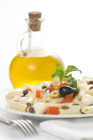 fresh macaroni mozzarella olives capers tomatoes salad isolatedの写真素材