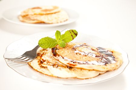 pile of pancakes drizzled in caramel and mintの写真素材