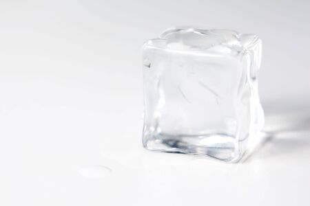 translucent ice cube isolated over white backgroundの写真素材