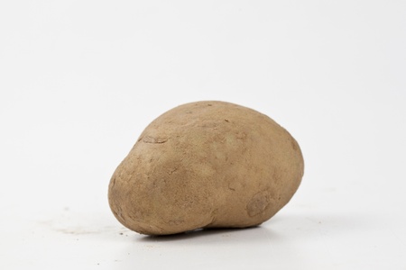Raw potatoes in burlap bag isolated over white backgroundの写真素材